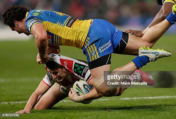 Gareth Widdop of the Dragons is tackled by Brad Takairangi of the Eels during the round 16 NRL match between the Parramatta Eels and the St George...