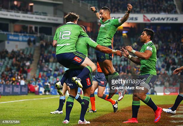 Patrick Osborne of the Highlanders celebrates with Richard Buckman and Aaron Smith after scoring the final try during the Super Rugby Semi Final...
