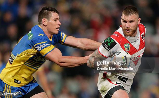 Josh Dugan of the Dragons is tackled during the round 16 NRL match between the Parramatta Eels and the St George Illawarra Dragons at Pirtek Stadium...