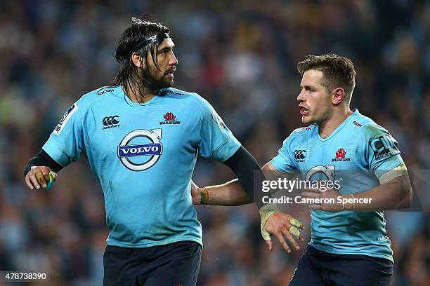 Bernard Foley of the Waratahs talks to Jacques Potgieter of the Waratahs as he runs off the field after receiving a yellow card during the Super...