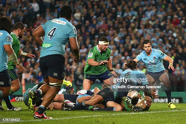 Jacques Potgieter of the Waratahs tackles Patrick Osborne of the Highlanders high as he attempts to score a try during the Super Rugby Semi Final...