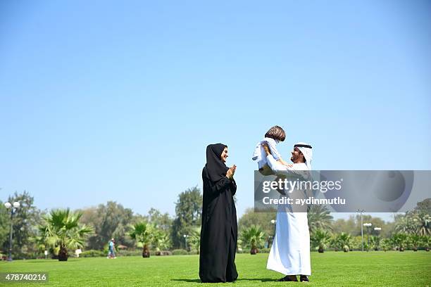 arab emirati family outdoors in park - arab family happy stock pictures, royalty-free photos & images