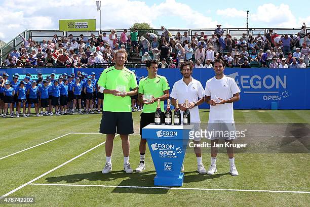 Chris Guccione of Australia and Andre Sa of Brazil pose with runners up Pablo Cuevas of Uruguay and David Marrero of Spain after their mens doubles...