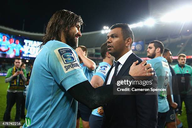 Jacques Potgieter of the Waratahs and injured Waratahs player Kurtley Beale talk following the Super Rugby Semi Final match between the Waratahs and...