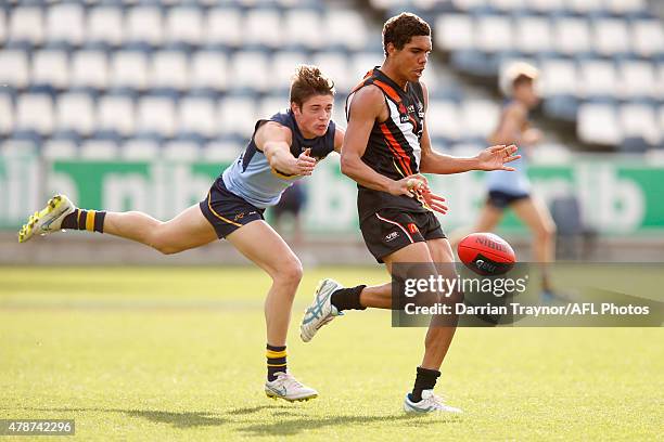 Lachlan Tiziani of NSW/ACT chases Jamie Hampton of Northern Territory during the U18 Championships match between NSW/ACT and Northern Territory at...