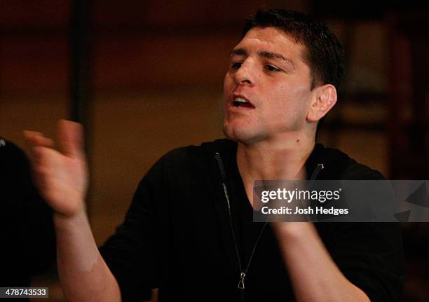 Welterweight star Nick Diaz heckles Johny Hendricks as he attempts to make weight during the UFC 171 official weigh-in at Gilley's Dallas on March...