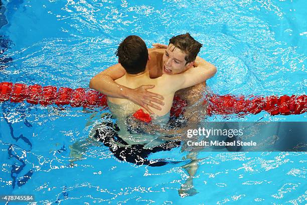 Duncan Scott of Great Britain celebrates winning the gold with teammate and silver medalist Cameron Kurle in the Men's 200m Freestyle final during...