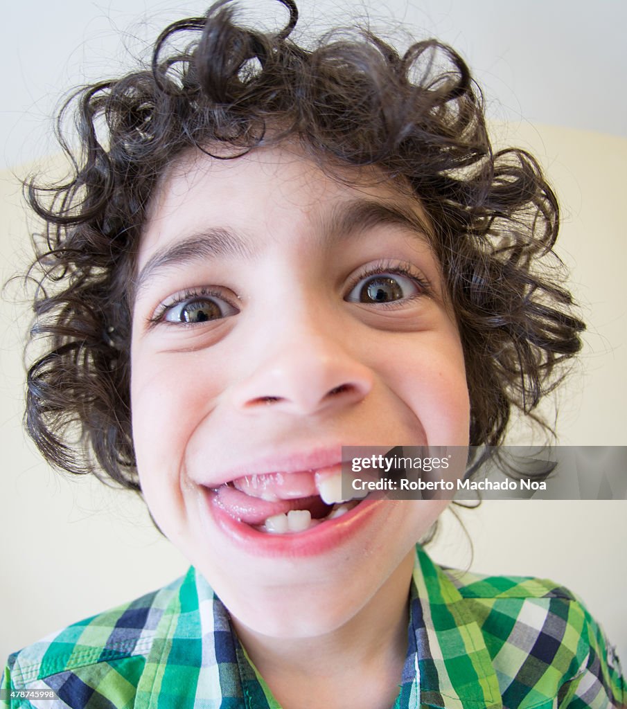 Wide angle distorted faces:Child boy with no milk teeth...