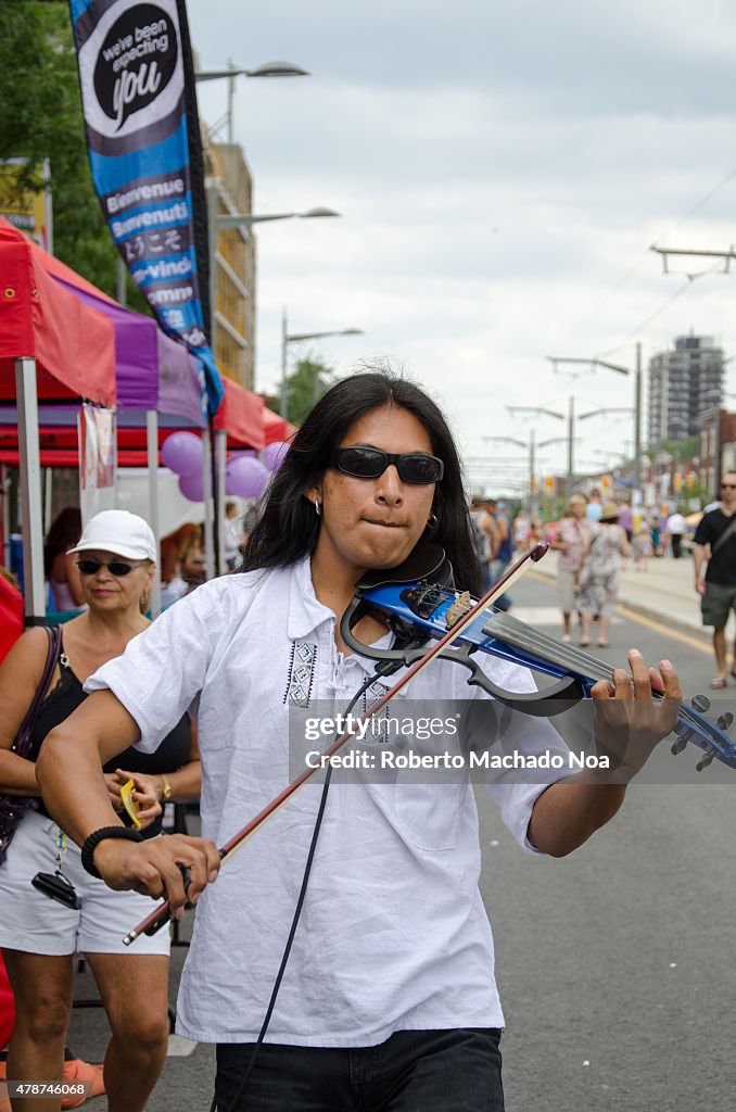 Salsa on St. Saint Clair Festival Scenes: A street musician...