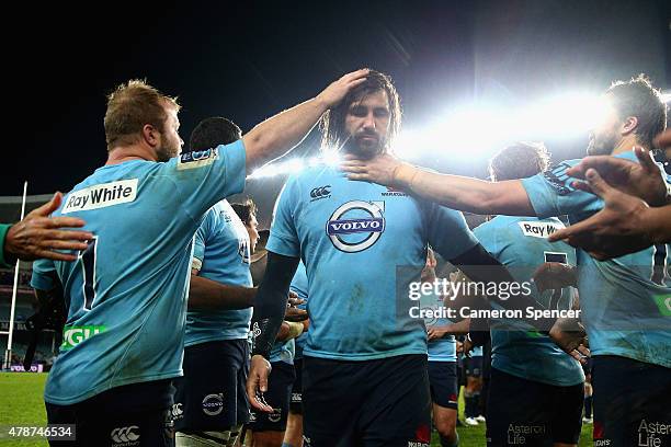 Jacques Potgieter of the Waratahs is clapped off the field by team mates after the Super Rugby Semi Final match between the Waratahs and the...