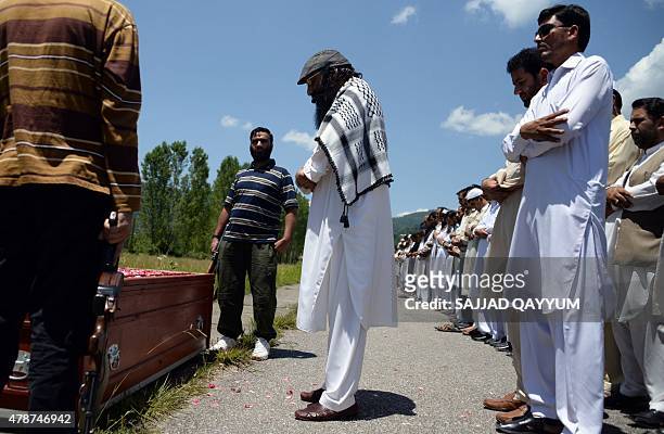 The head of the Kashmiri militant group Hizbul Mujahideen Syed Salahuddin leads prayers for an alleged Pakistani militant was killed in...