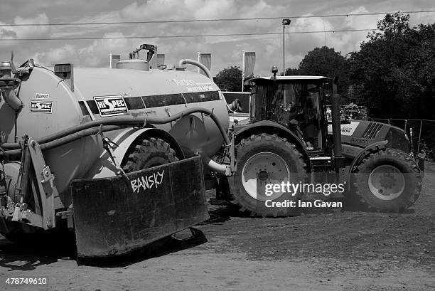 Tractor and tanker drive through the interstage area at the Glastonbury Festival at Worthy Farm, Pilton on June 27, 2015 in Glastonbury, England. Now...