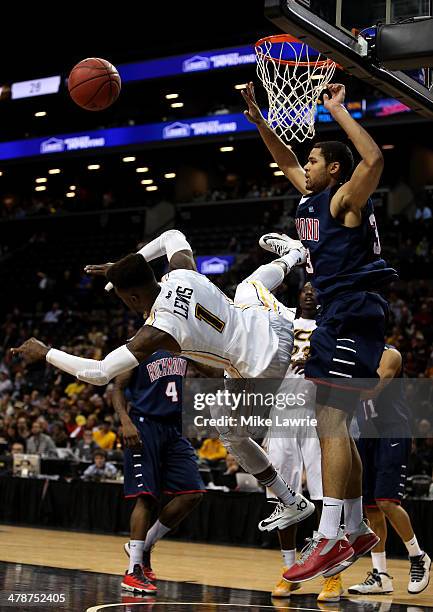 JeQuan Lewis of the Virginia Commonwealth Rams falls to the court after being fouled against Alonzo Nelson-Ododa of the Richmond Spiders in the...