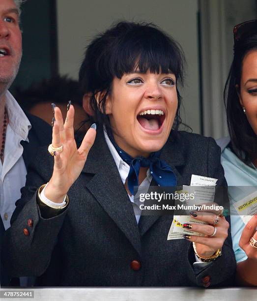 Lily Allen cheers and celebrates as she watches the Cheltenham Gold Cup on Day 4 of the Cheltenham Festival at Cheltenham Racecourse on March 14,...