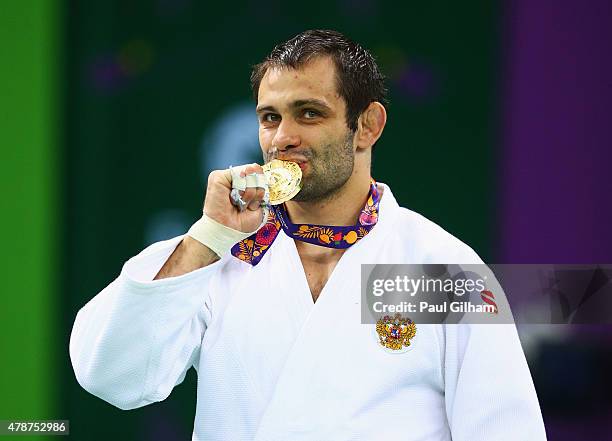 Gold medalist Kirill Denisov of Russia poses on the medal podium following the Men's Judo -90kg Finals during day fifteen of the Baku 2015 European...