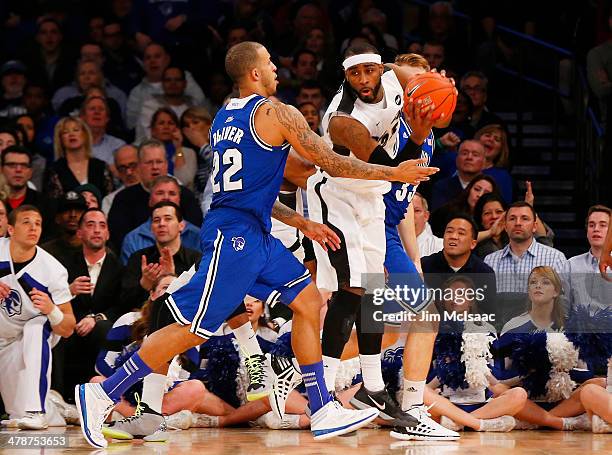 LaDontae Henton of the Providence Friars vies for possesion with Brian Oliver and Patrik Auda of the Seton Hall Pirates in the second half during the...