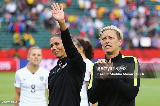 Abby Wambach of United States of America and Shannon Boxx acknowledge fans following the FIFA Women's World Cup Canada 2015 Round of 16 match between...