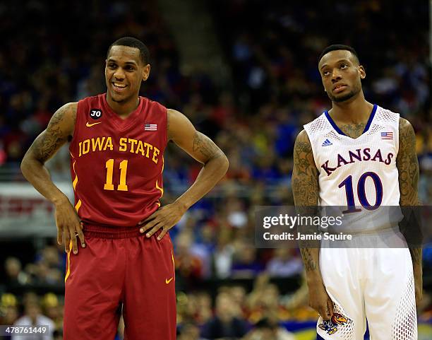 Monte Morris of the Iowa State Cyclones smiles as he stands next to a dejected Naadir Tharpe of the Kansas Jayhawks during the Big 12 Basketball...