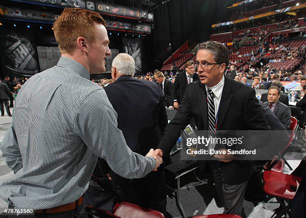 General Manager Dean Lombardi of the Los Angeles Kings shakes the hand of 99th overall pick by the Los Angeles Kings Austin Wagner during the 2015...