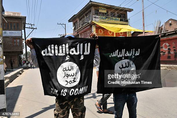 Kashmiri protesters displaying the flags of ISIS during a protest against alleged desecration of Jamia Masjid by police personnel yesterday after...