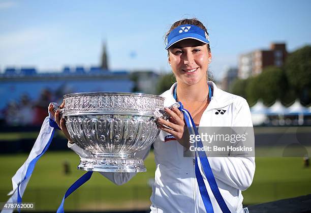 Belinda Bencic of Switzerland poses with the trophy after defeating Agnieszka Radwanska of Poland on day seven of the Aegon International at...