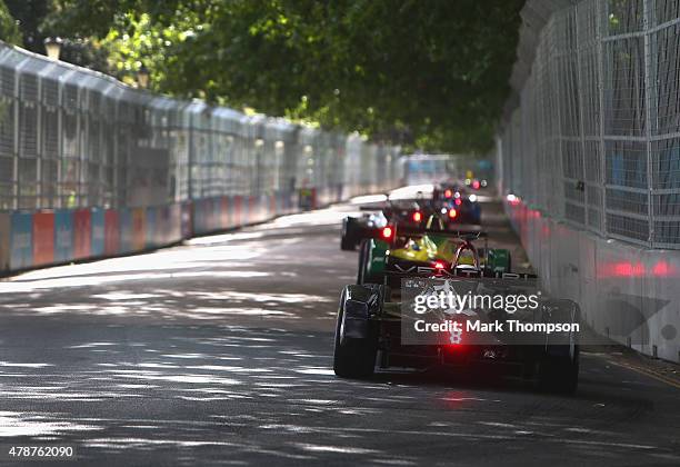 Formula E cars drive through battersea park during the FIA Formula E Visa championship, ePrix at battersea park on June 27, 2015 in London, England.