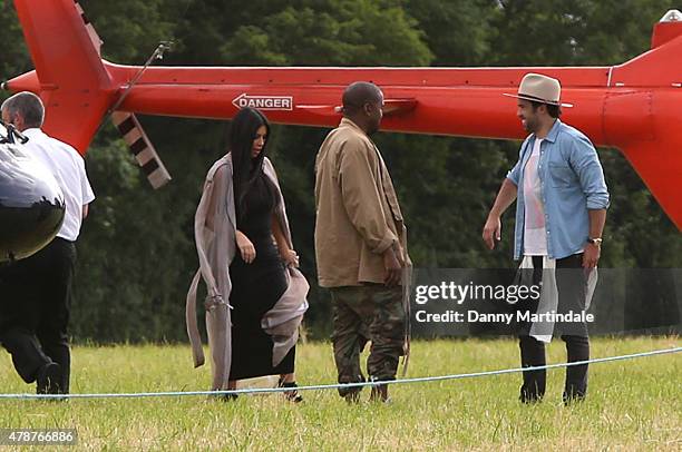 Rapper Kanye West and wife Kim Kardashian arrive in a helecopter at the Glastonbury Festival at Worthy Farm, Pilton on June 27, 2015 in Glastonbury,...