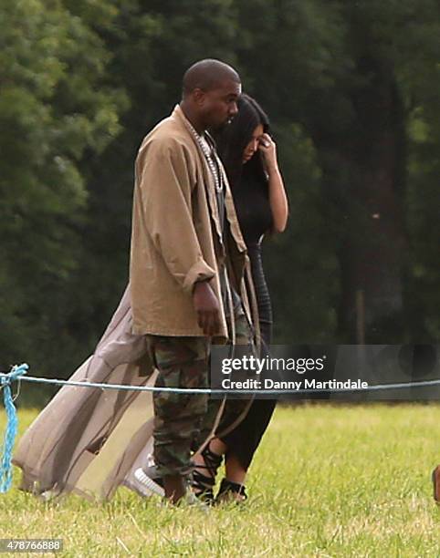 Rapper Kanye West and wife Kim Kardashian arrive in a helecopter at the Glastonbury Festival at Worthy Farm, Pilton on June 27, 2015 in Glastonbury,...