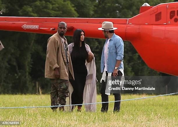 Rapper Kanye West and wife Kim Kardashian arrive in a helecopter at the Glastonbury Festival at Worthy Farm, Pilton on June 27, 2015 in Glastonbury,...