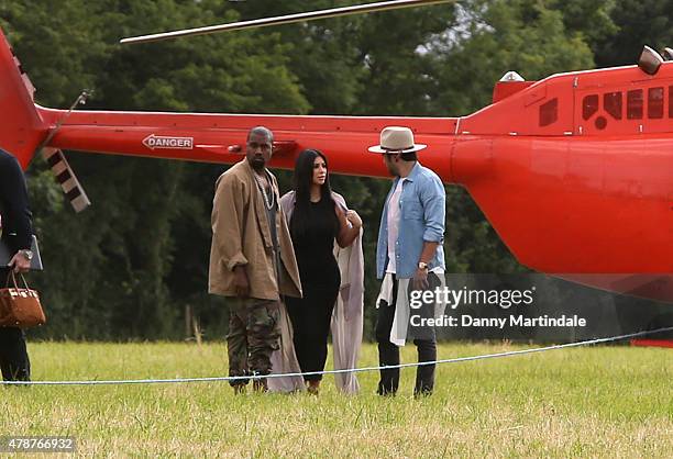 Rapper Kanye West and wife Kim Kardashian arrive in a helecopter at the Glastonbury Festival at Worthy Farm, Pilton on June 27, 2015 in Glastonbury,...