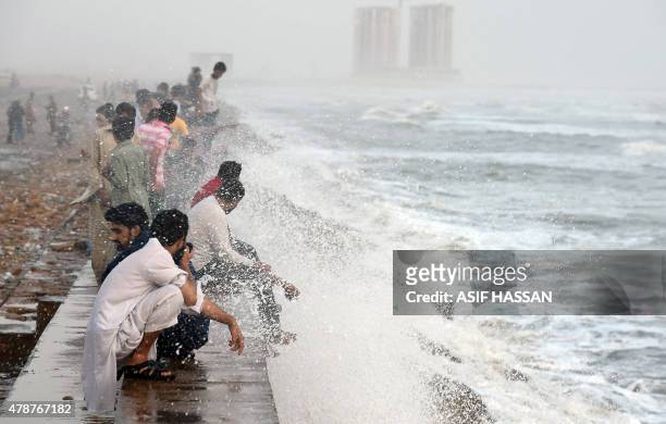 Pakistani youths cool themselve at the Clifton beach during heatwave in Karachi on June 27, 2015. More than 1,000 people have died as a result of...