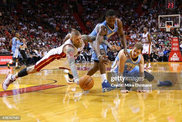 Chris Andersen of the Miami Heat, Timofey Mozgov and Kenneth Faried of the Denver Nuggets scramble for a loose ball during a game at American...