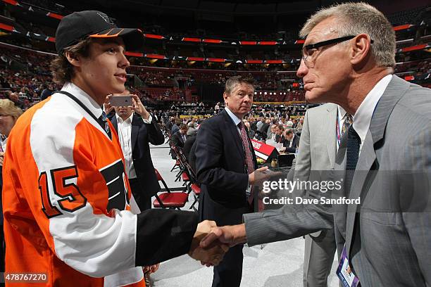 Samuel Dove-Mcfalls, 98th overall pick by the Philadelphia Flyers, shakes the hand of Paul Holmgren of the Philadelphia Flyers during the 2015 NHL...