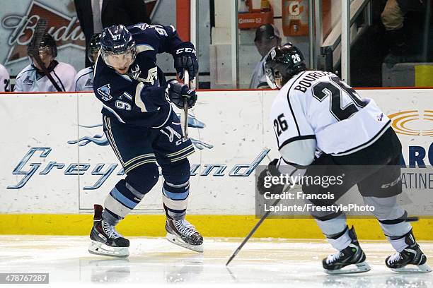 Jeremy Roy of the Sherbrooke Phoenix fires a shot against Jonathan Boucher of the Gatineau Olympiques during the QMJHL game on March 14, 2014 at...