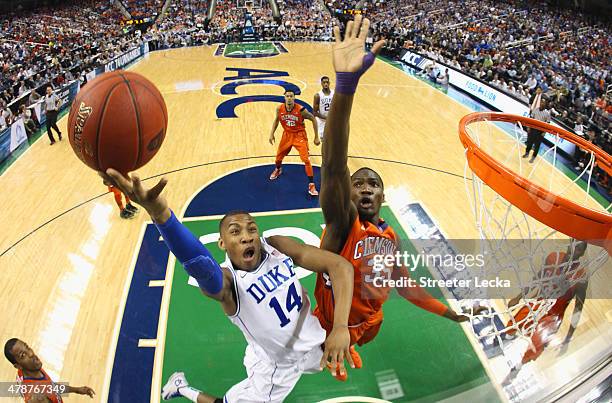 Rasheed Sulaimon of the Duke Blue Devils drives to the basket against Landry Nnoko of the Clemson Tigers during the quarterfinals of the 2014 Men's...