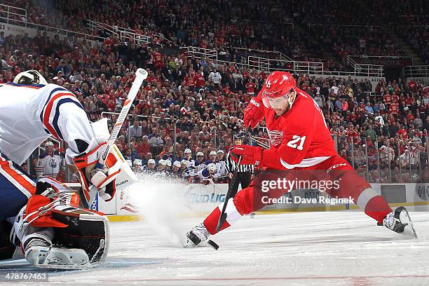 Tomas Tatar of the Detroit Red Wings makes a move with the puck and beats Viktor Fasth of the Edmonton Oilers in a shootout to clinch the win during...