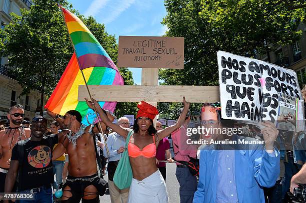 Transsexual holds a cross like Jesus to ask for the right to use their own body as they want as thousands of people gather to support gay rights by...