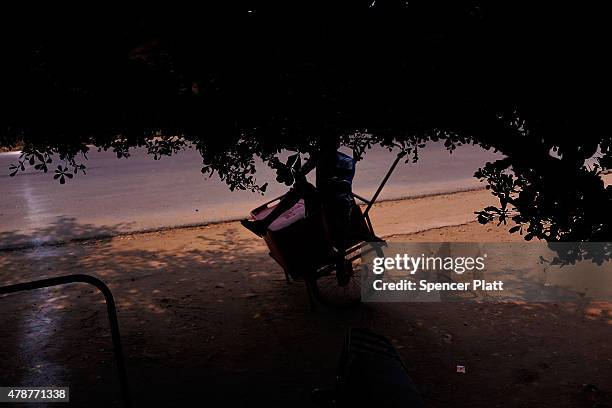 Street vendor is viewed relaxing by the beach on June 27, 2015 in Bujumbura, Burundi. Burundi is one of the worlds poorest countries with food...