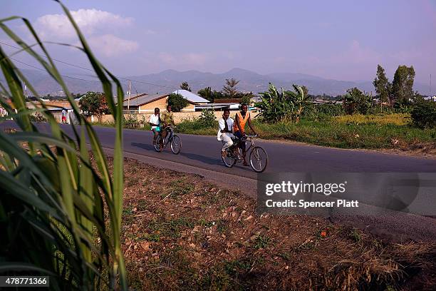 People cycle along a road on June 27, 2015 in Bujumbura, Burundi. Burundi is one of the worlds poorest countries with food shortages throughout the...