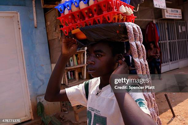 Street vendor sells food on June 27, 2015 in Bujumbura, Burundi. Burundi is one of the worlds poorest countries with food shortages throughout the...