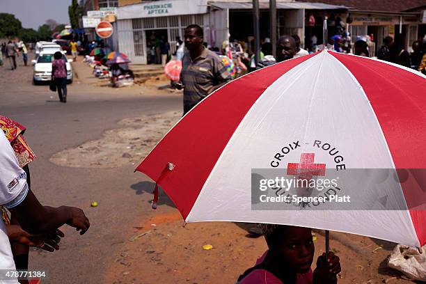 People walk through a market on June 27, 2015 in Bujumbura, Burundi. Burundi is one of the worlds poorest countries with food shortages throughout...