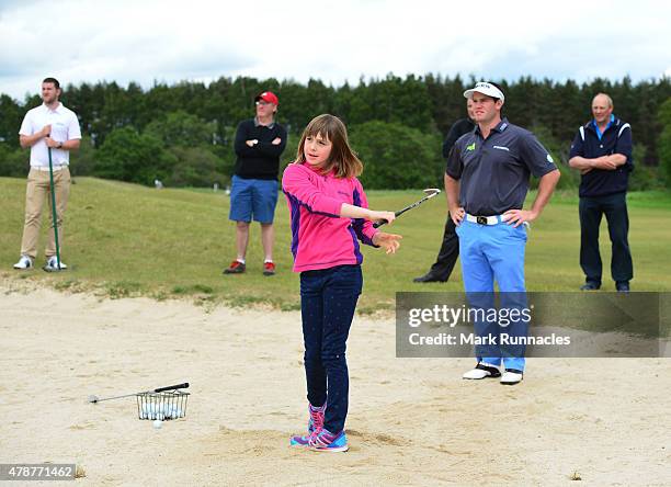 Riccardo Gouveia of Portugal giving local children a bunker lesson during the third round of the 2015 SSE Scottish Hydro Challenge at the MacDonald...