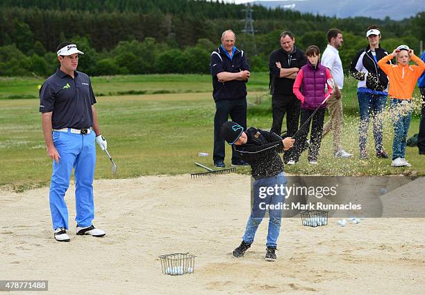 Riccardo Gouveia of Portugal giving local children a bunker lesson during the third round of the 2015 SSE Scottish Hydro Challenge at the MacDonald...