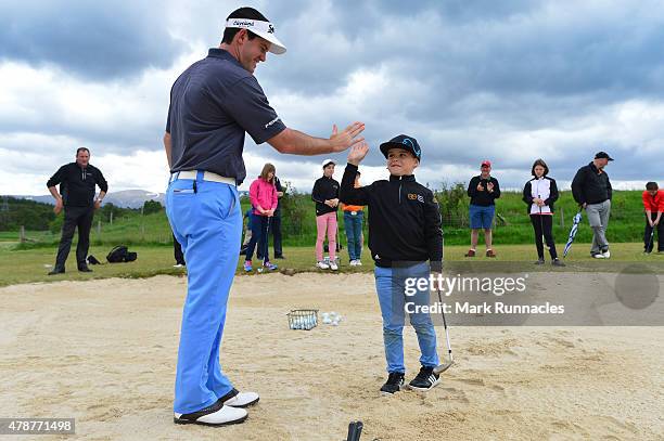Riccardo Gouveia of Portugal giving local children a bunker lesson during the third round of the 2015 SSE Scottish Hydro Challenge at the MacDonald...