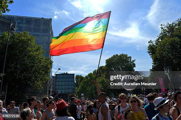 Rainbow flag waves in the sun as thousands of people gather to support gay rights by celebrating during the Gay Pride Parade on June 27, 2015 in...