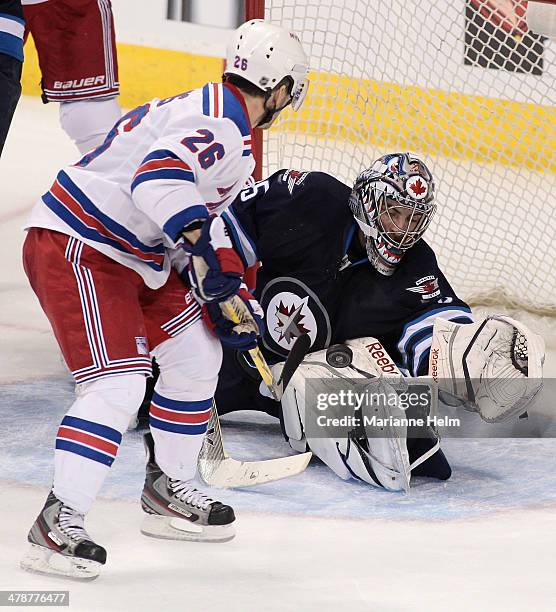 Al Montoya of the Winnipeg Jets blocks a shot on goal by Martin St. Louis of the New York Rangers in third period action in an NHL game at the MTS...