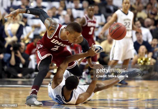 Derrick Gordon of the Massachusetts Minutemen goes for a loose ball against Nick Griffin of the George Washington Colonials in the second half during...