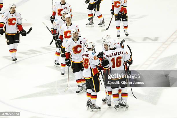 Brian McGrattan, Ben Hanowski and the Calgary Flames celebrate a win against the Dallas Stars at the American Airlines Center on March 14, 2014 in...