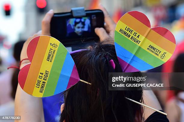 Person takes a picture during the annual Lesbian, Gay, Bisexual and Transgender Pride Parade in Milan, on June 27, 2015. AFP PHOTO / GIUSEPPE CACACE