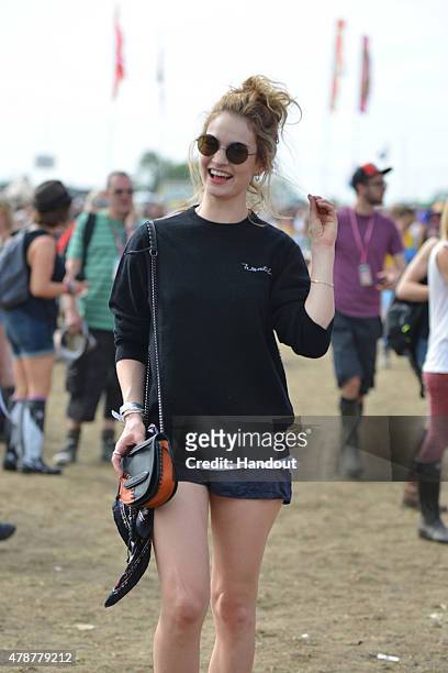 In this handout image supplied by Coach, Lily James wearing Coach attends the Glastonbury Festival at Worthy Farm, Pilton on June 26, 2015 in...